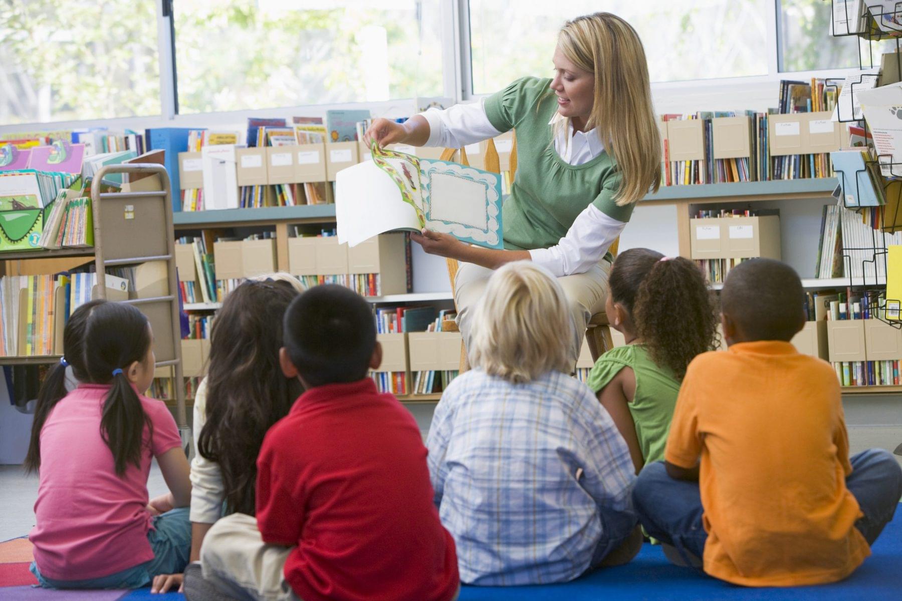 A teacher is implementing Shared Reading and her students are smiling!